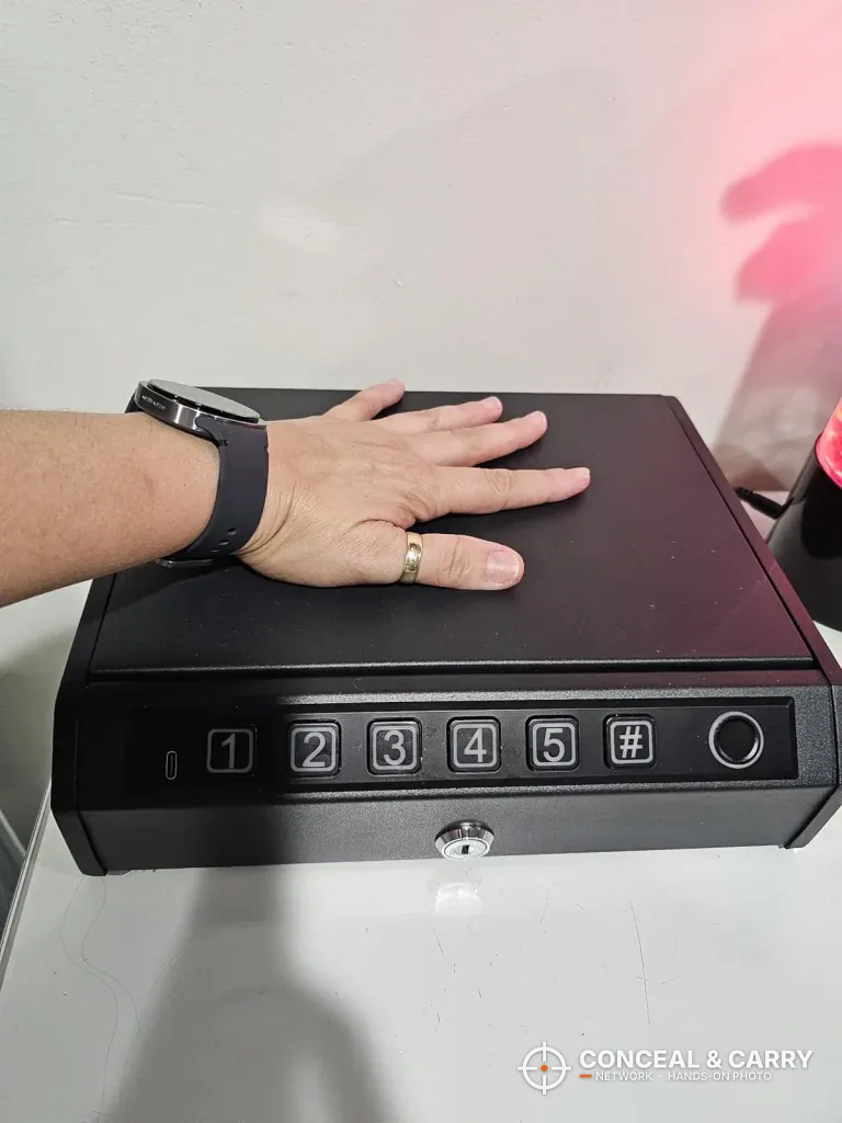 Hand on top of the closed AIRMuch safe to show its size