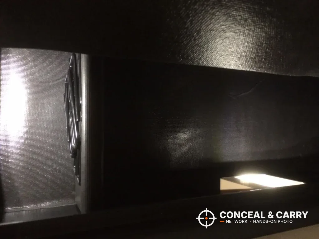 Low-light close-up inside the Barska rifle safe near the door
