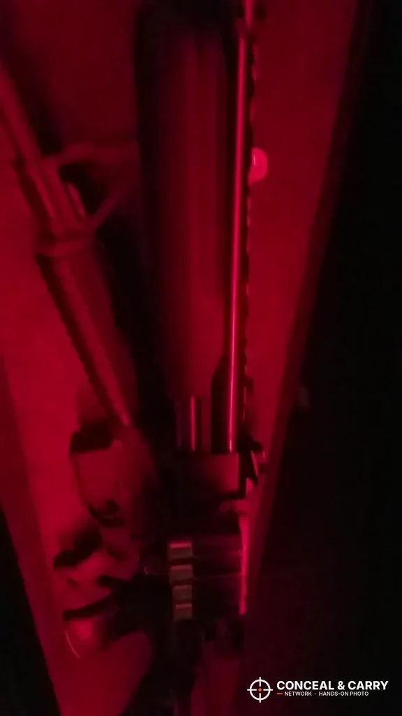 Rifle standing inside the Barska biometric rifle safe in red light