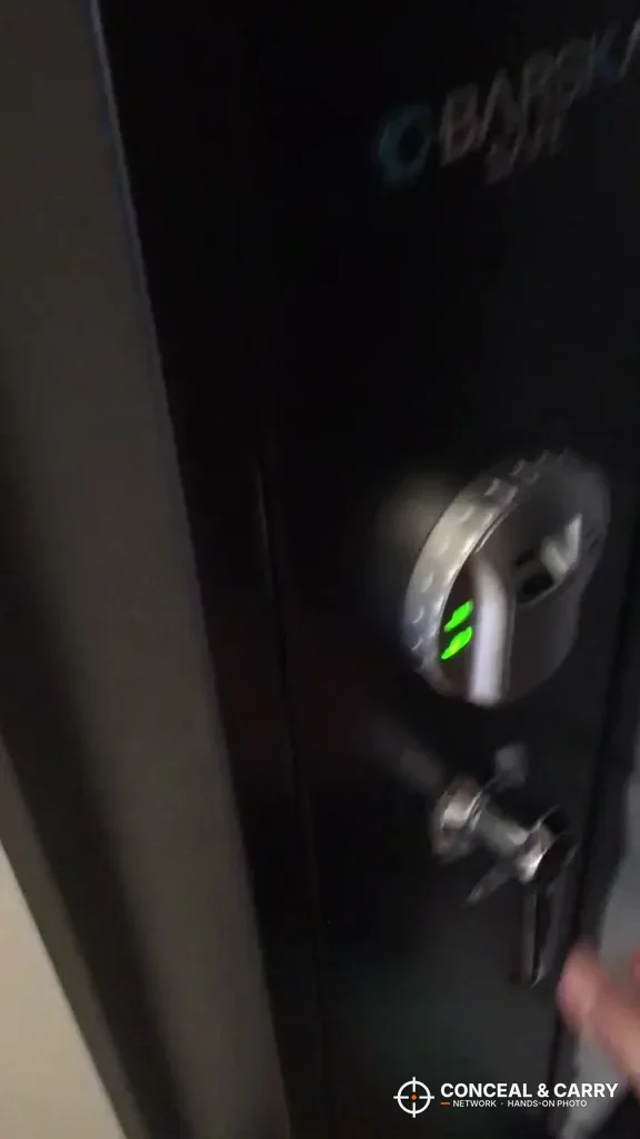 Barska rifle safe door with the fingerprint reader lit green above the key lock