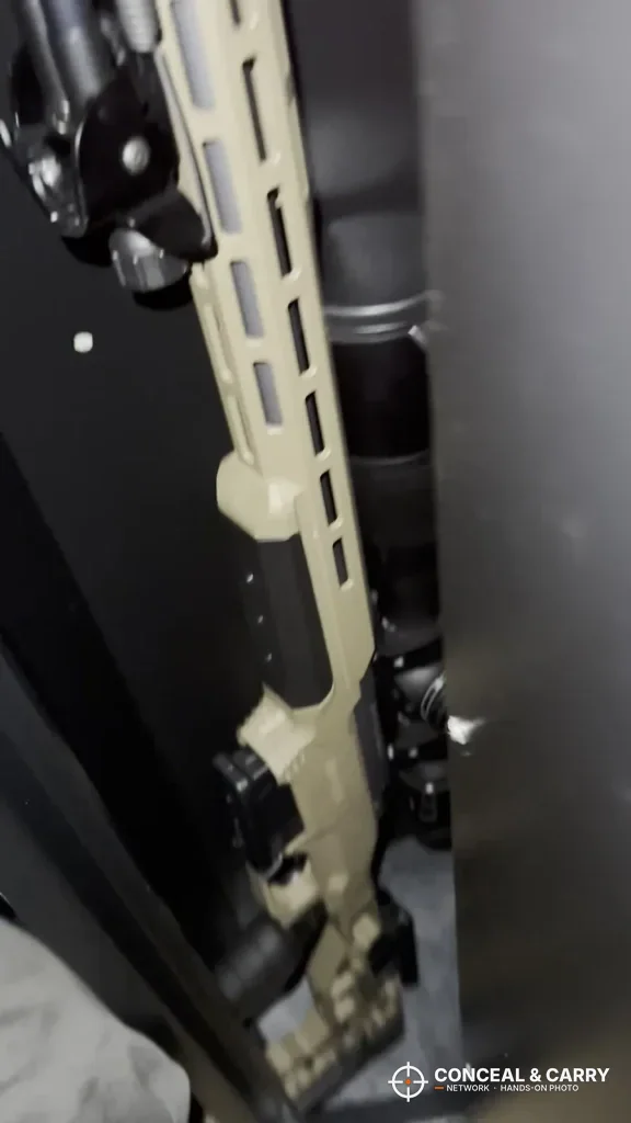 Rifle with a tan handguard standing inside the Barska biometric rifle safe