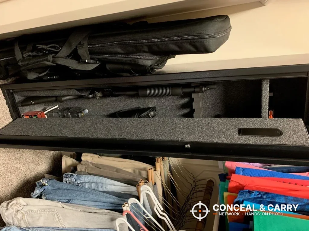 Carpet-lined Barska rifle safe interior in a closet