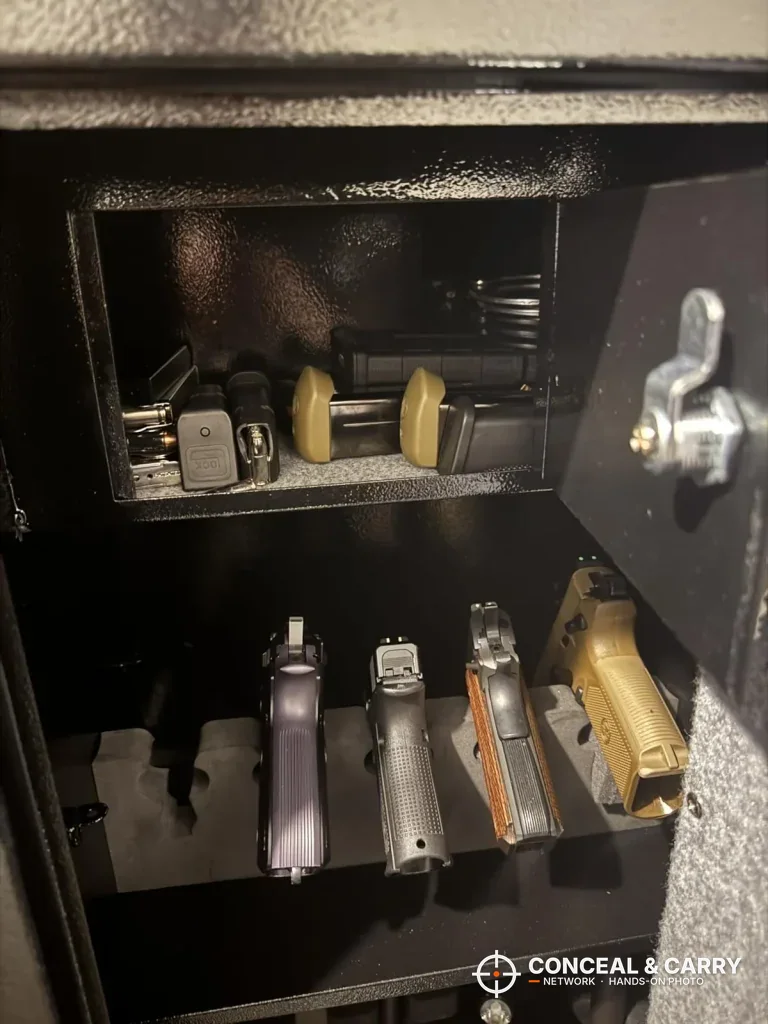 Upper section of the BBRKIN rifle safe with handguns lined up on the shelf