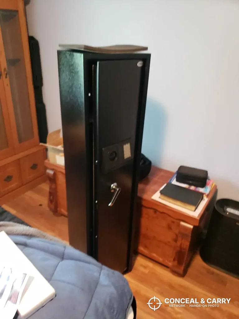 BBRKIN rifle safe closed beside a wooden nightstand