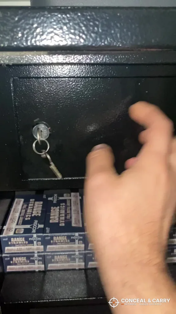 Key in the lock of the BBRKIN rifle safe inner lock box with ammunition boxes below
