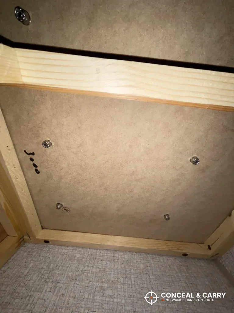 Screw holes laid out on a wood panel for the BBRKIN Slide-Away safe