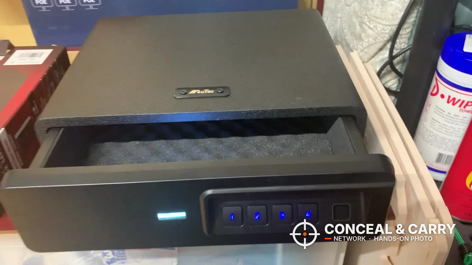 BBRKIN Slide-Away biometric safe with the drawer partway open, egg-crate foam and lit keypad