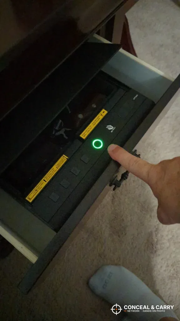 Finger on the BE-TECH lock box fingerprint reader with the ring lit green