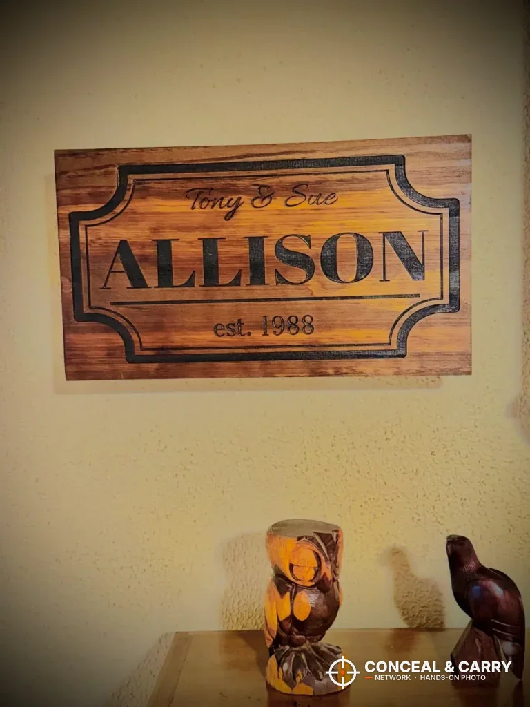Bellewood family name sign hanging on a wall above a shelf