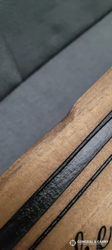 Close-up of the Bellewood sign's edge with a nick in the wood