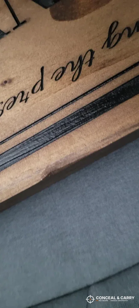 Close-up of the lettering and edge on a Bellewood hidden gun sign