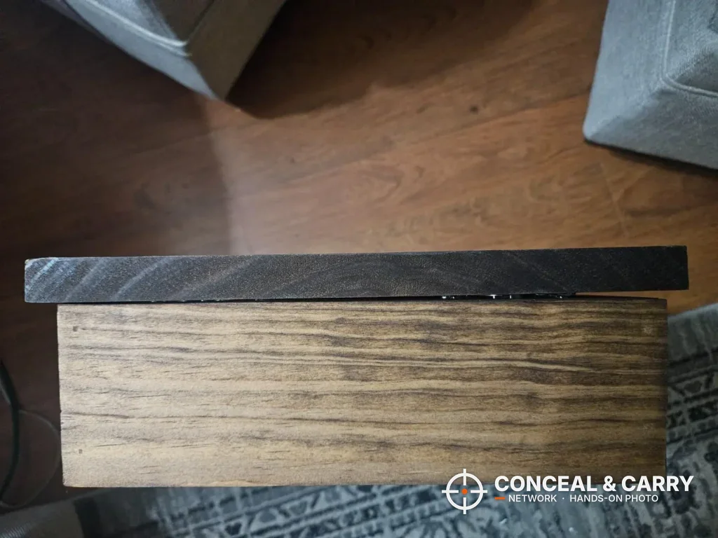 Side view of the Bellewood hidden gun sign lying flat, showing the depth of the cabinet