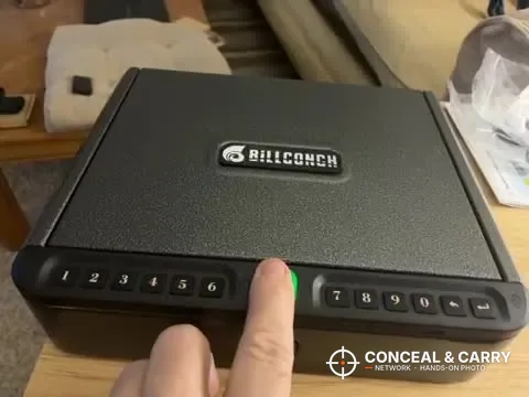 Finger on the BILLCONCH biometric handgun safe fingerprint reader with the green light on