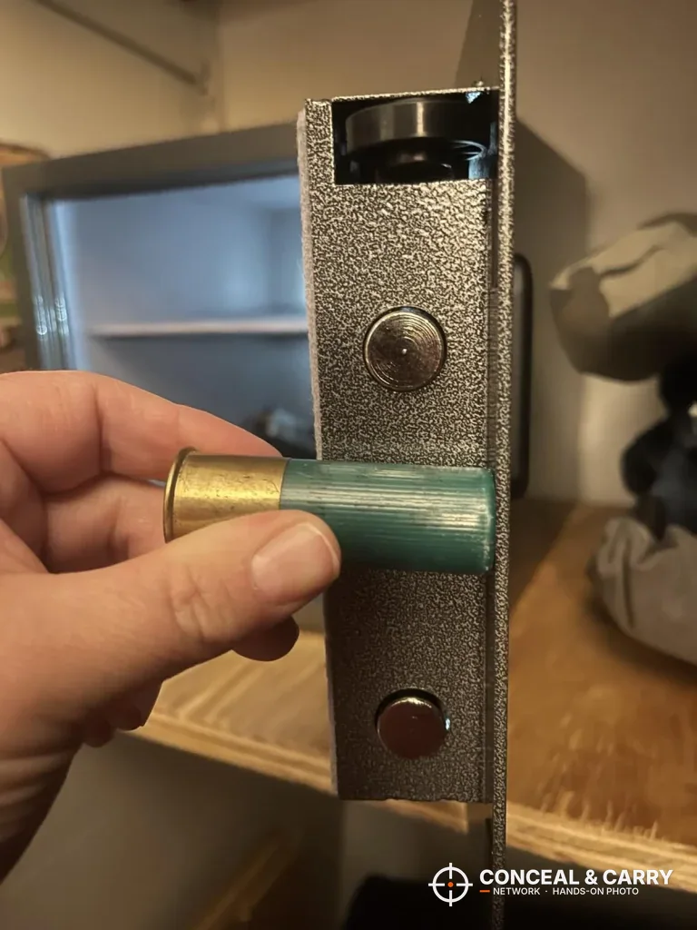 Shotgun shell held beside the Billconch safe door bolts for size