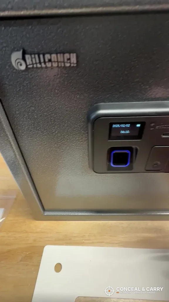 Close-up of the Billconch safe LCD screen and blue fingerprint reader
