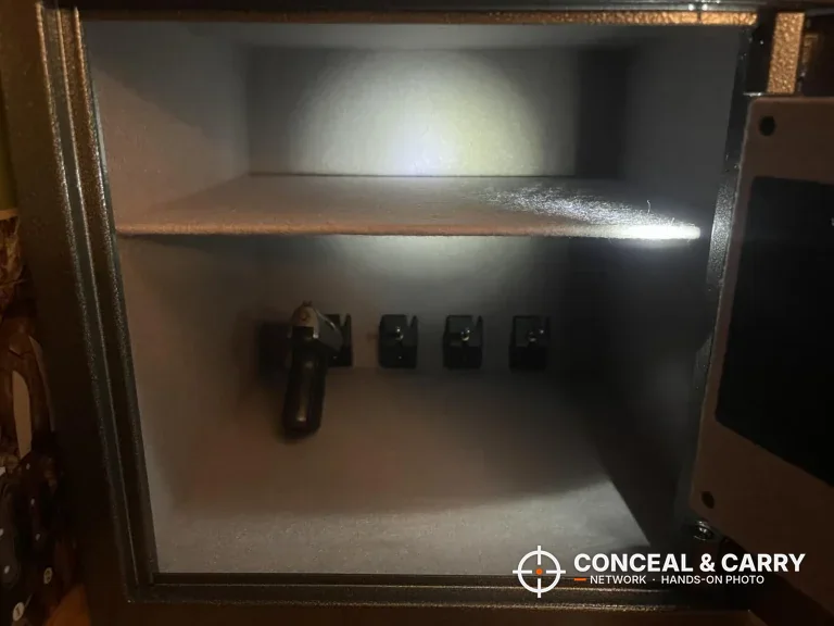 Billconch multi-pistol smart safe open with a pistol on the bracket and the LED light on