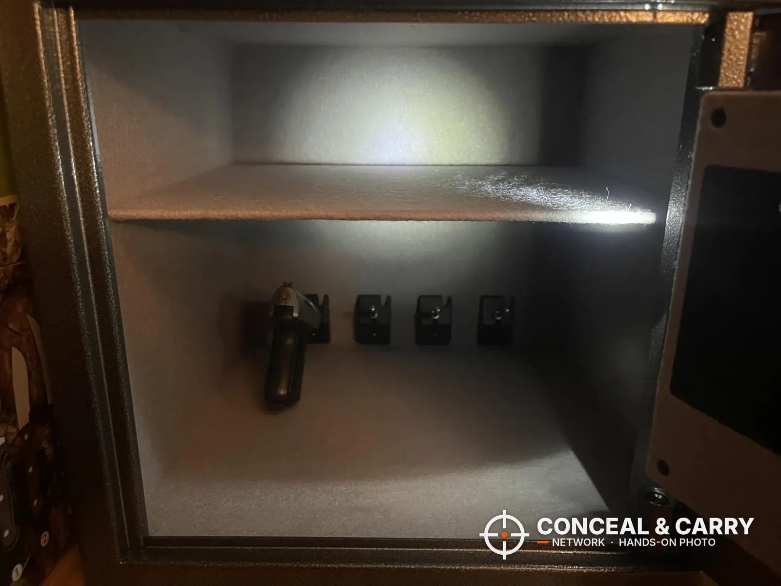 Billconch multi-pistol smart safe open with a pistol on the bracket and the LED light on