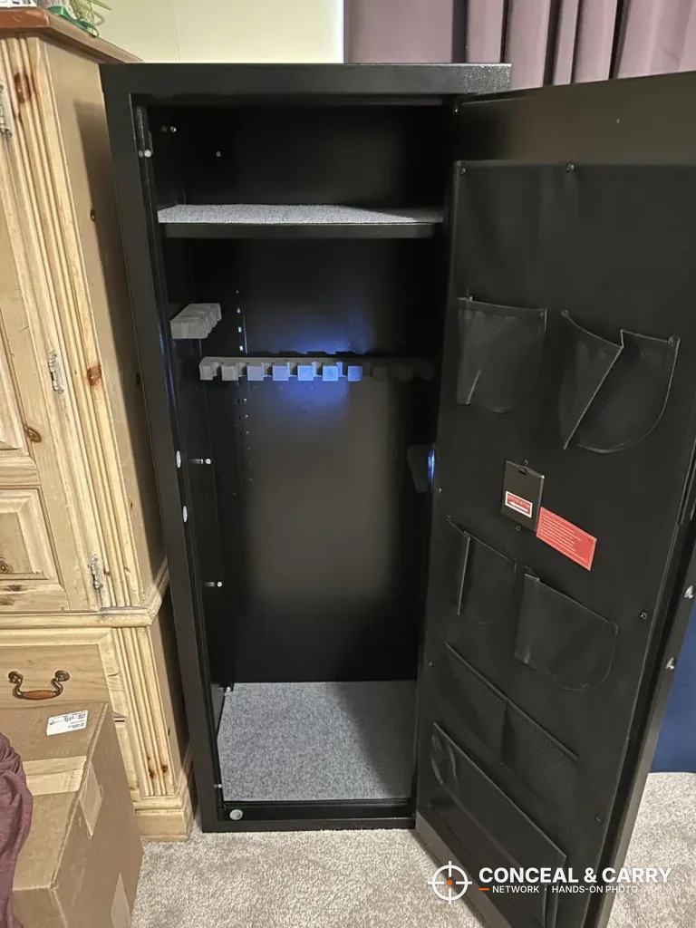 Bonusall rifle safe open with a top shelf, gun rack and organizer pockets on the door