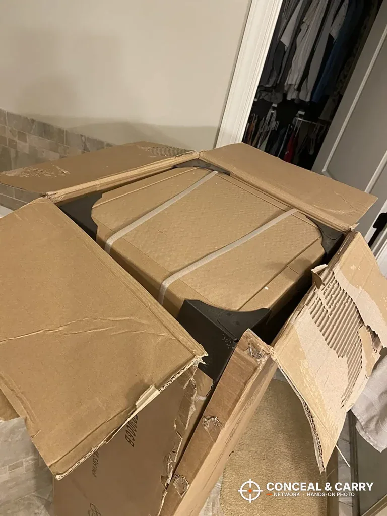 Opened Bonusall 12-15 gun safe shipping carton on a closet floor