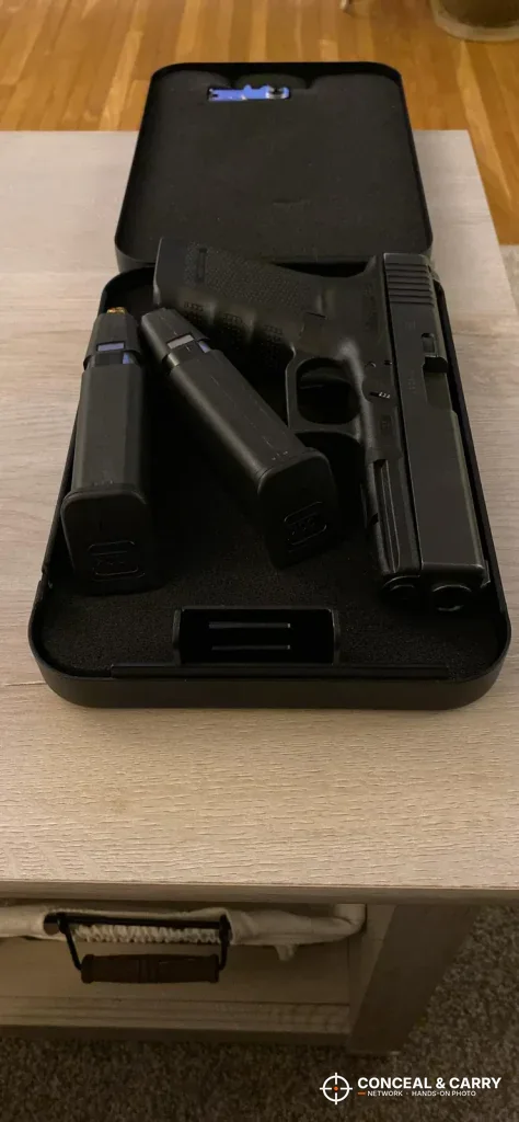 Dalmbox lock box open with a pistol and magazines inside