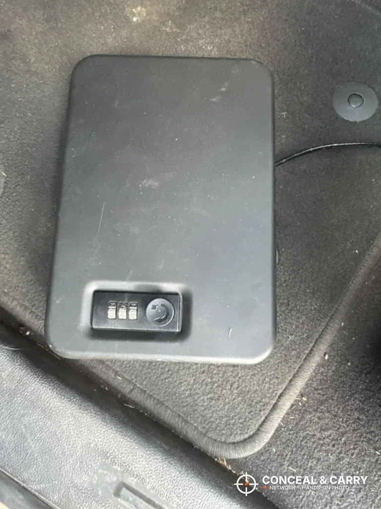 Closed Dalmbox lock box sitting on a car floor mat