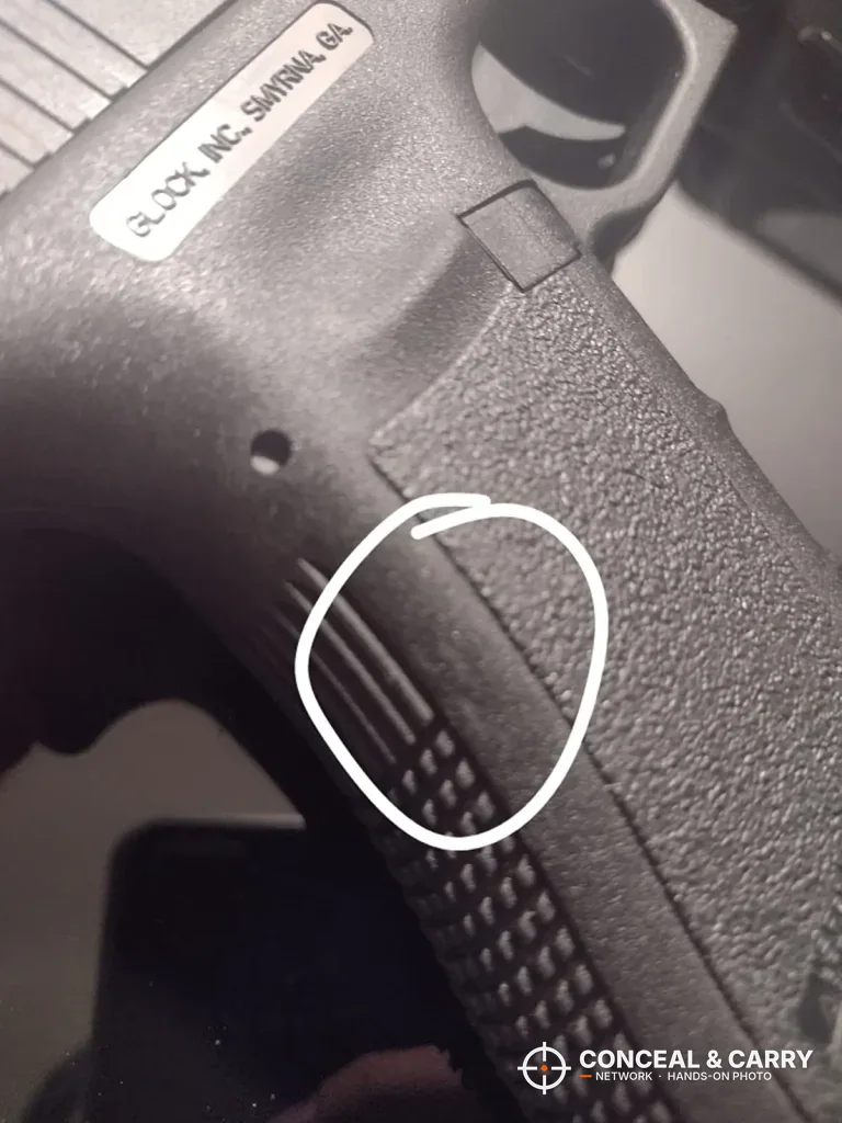 Pistol grip close-up with a spot circled, from the Dalmbox lock box photos