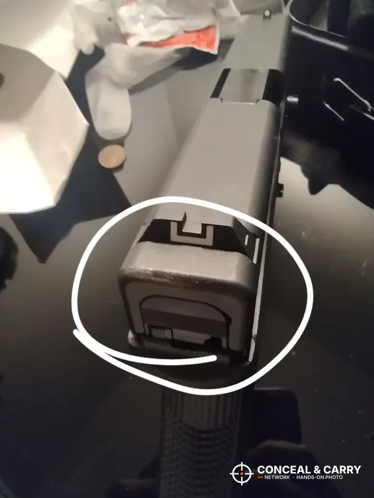 Rear of a pistol slide with a spot circled, from the Dalmbox lock box photos