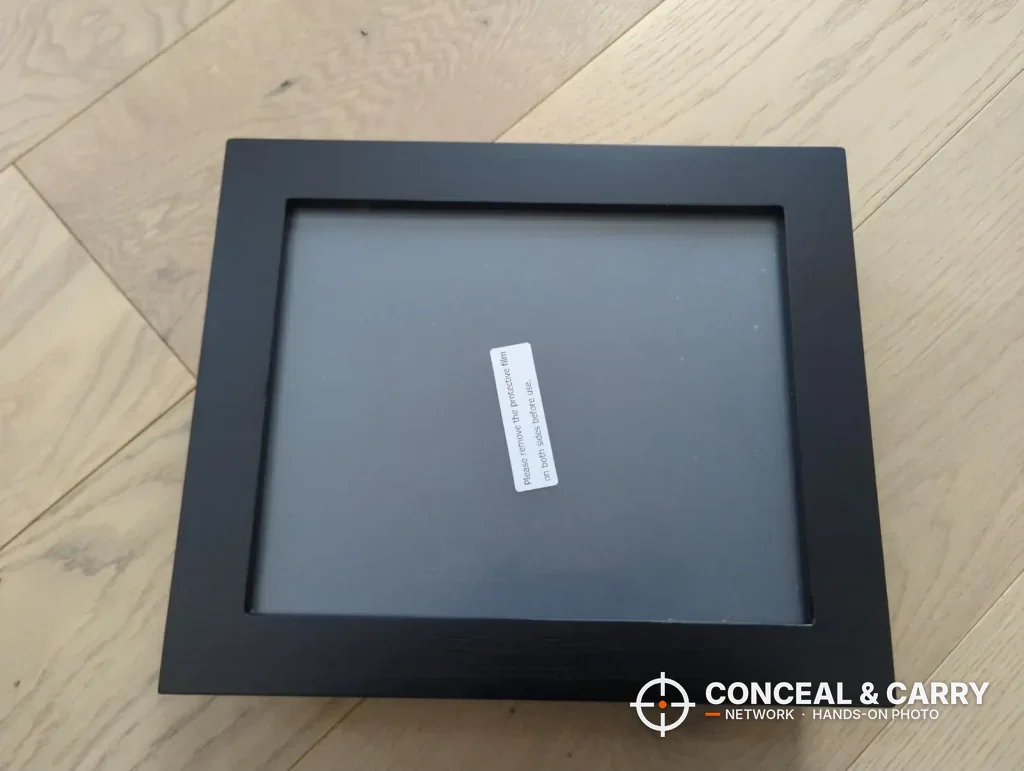 Front of the Dononr hidden storage frame with a label on the clear panel