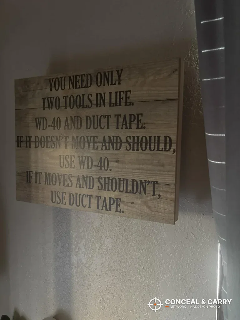 Wood-look WD-40 and duct tape wall sign, the kind of decor the Dononr frame has to blend in with