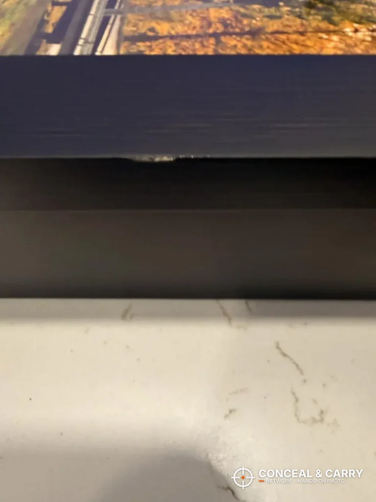 Close-up of the bottom edge of the Dononr frame on a wall
