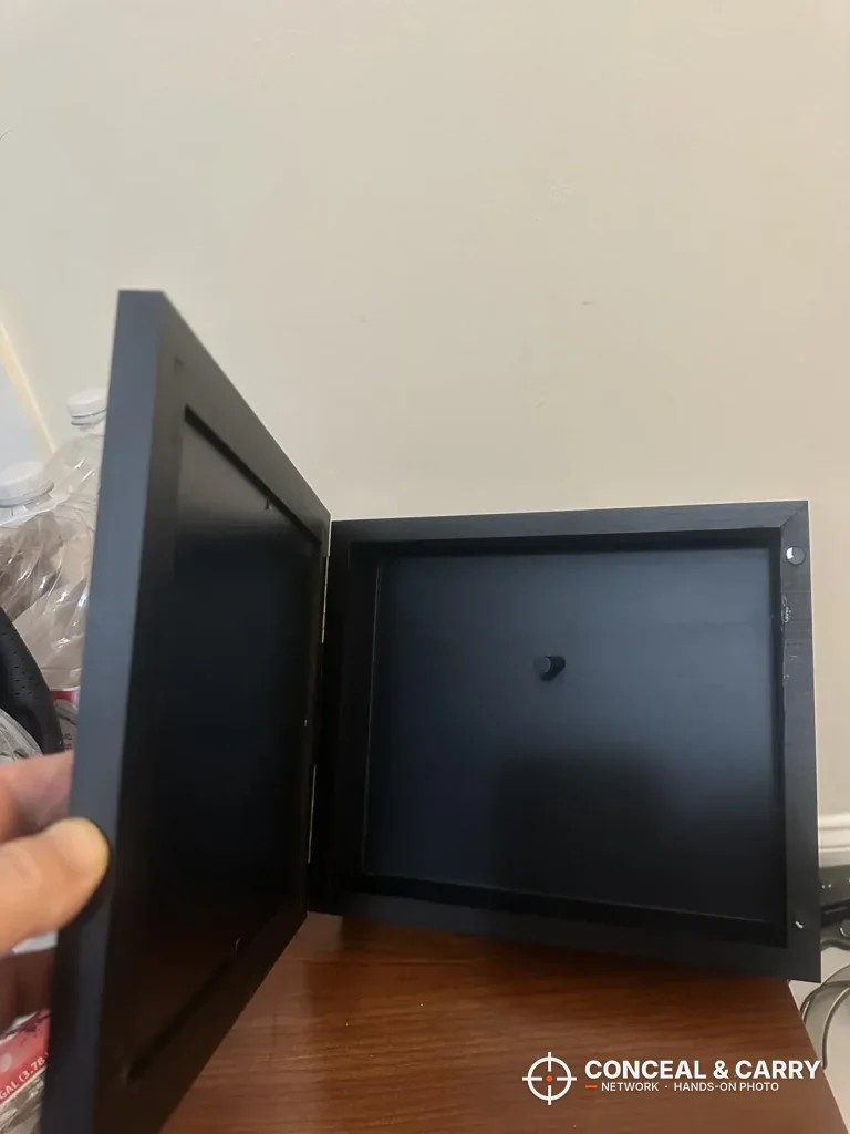 Dononr hidden gun storage shelf swung open on a table to show the empty compartment