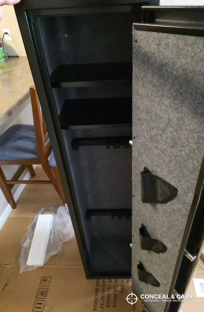 EMAXEE gun cabinet door open with the felt-lined door and shelves up top