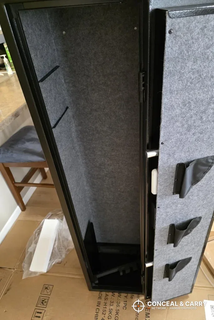 Felt-lined interior and door pockets of the open EMAXEE gun cabinet