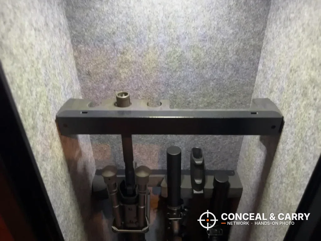 Long guns standing under the upper rack inside the EMAXEE cabinet