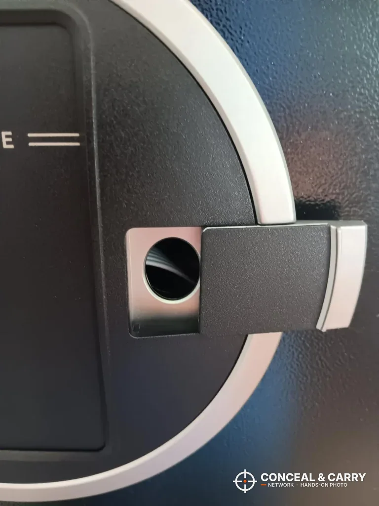 Close-up of the chrome-ringed round panel on the EMAXEE cabinet door