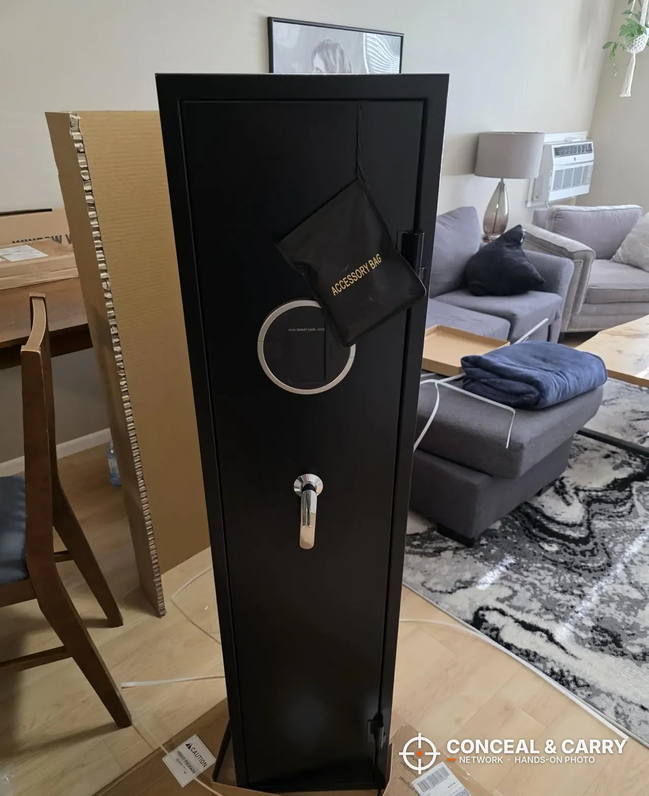 EMAXEE 5-8 gun cabinet standing closed, front view with the round panel and key lock