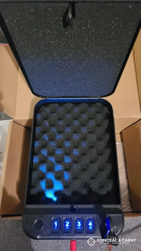 Fitsafe Bluetooth biometric safe open with the interior light on the foam and the keypad lit blue