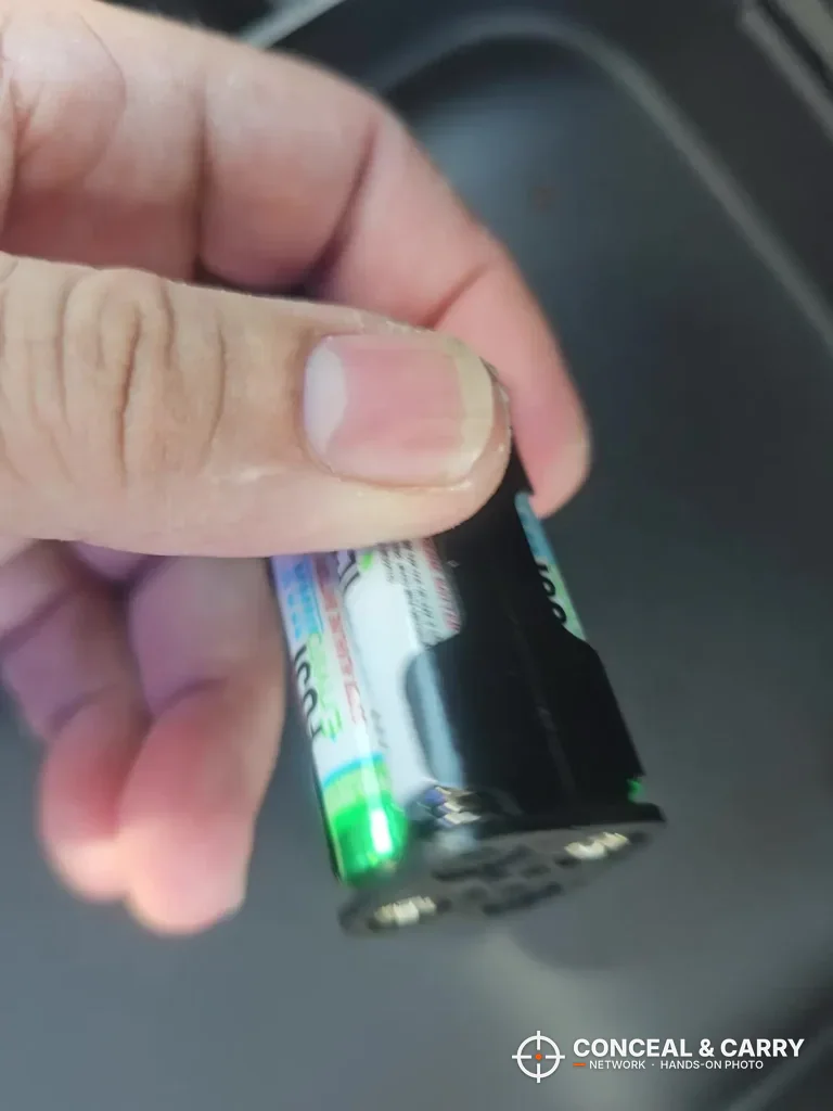 Hand holding a battery over the open Fitsafe safe