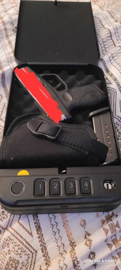 Holstered pistol inside the open Fitsafe biometric safe