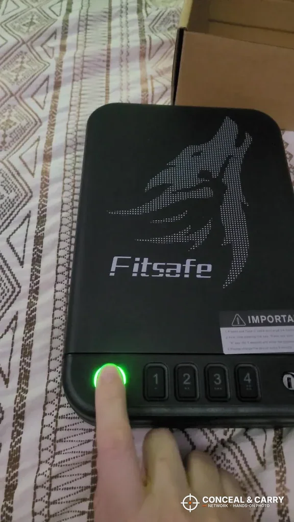 Finger on the Fitsafe fingerprint reader lit green
