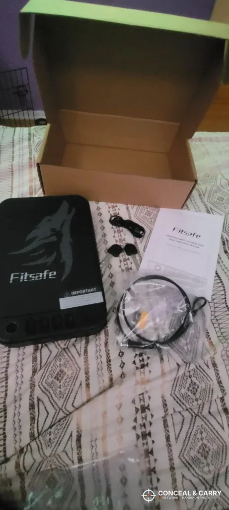 Fitsafe safe unboxed with its security cable and paperwork