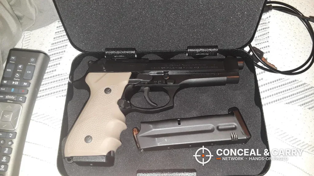 Full-size pistol with a tan grip and a spare magazine in the FSDC lock box