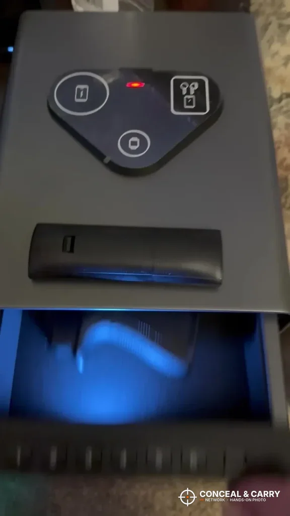 Top of the FTOP safe with the triangle charging pad and the drawer open below