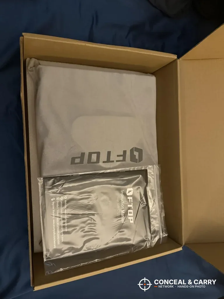FTOP safe in its gray bag inside the open carton with a bag of parts