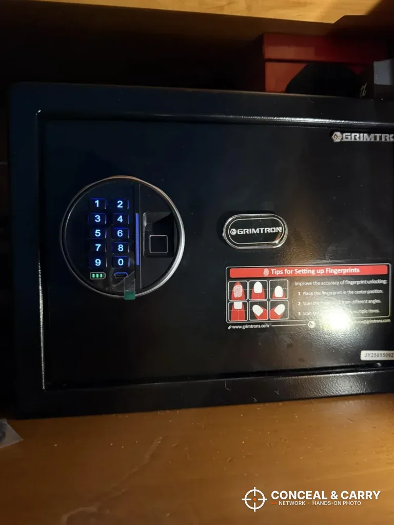 Grimtron 4-pistol safe keypad lit blue on the front of the door