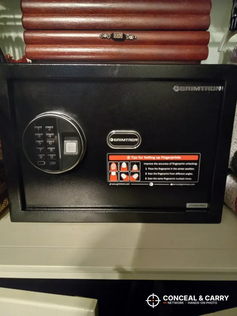 Grimtron 4-pistol biometric safe closed on a shelf