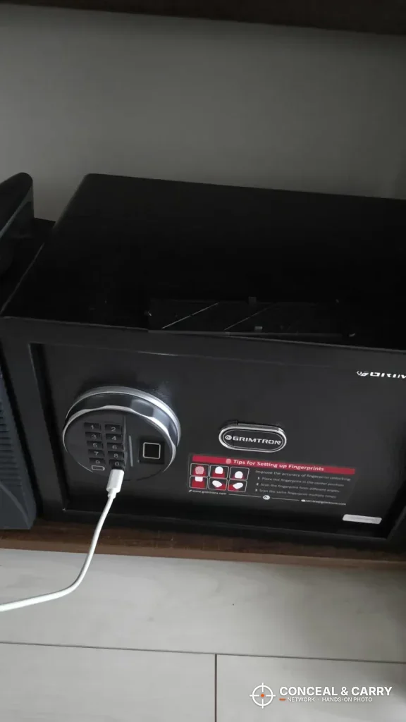 Grimtron 4-pistol safe with a cord plugged into the bottom of the keypad