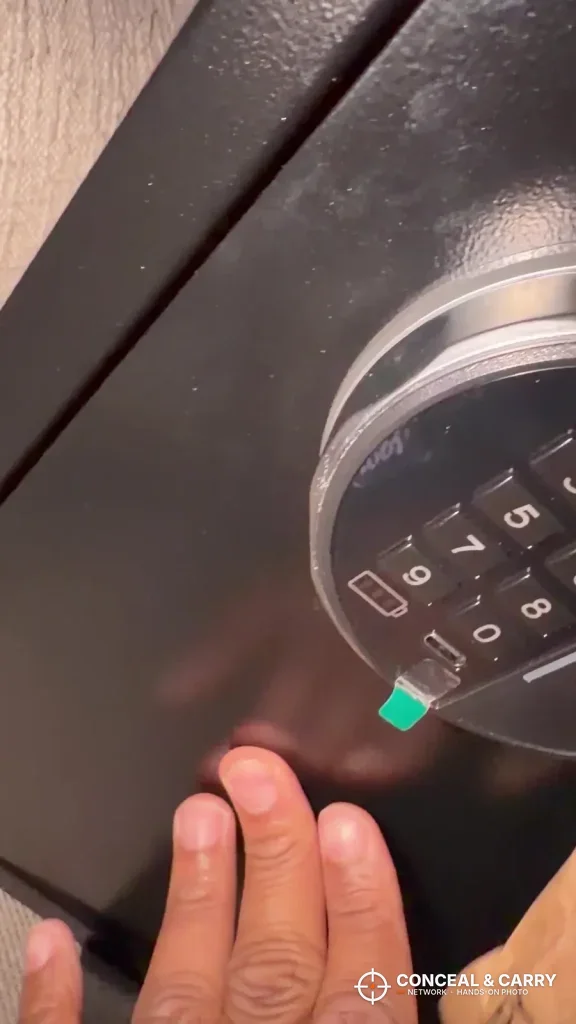 Close-up of the Grimtron 4-pistol safe keypad with the green status light on