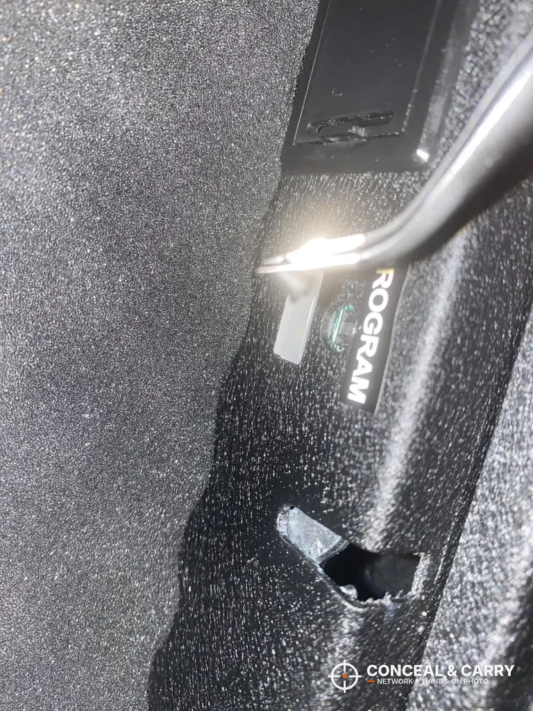 Inside the Grimtron heavy-duty safe lid, with a button marked PROGRAM beside the latch