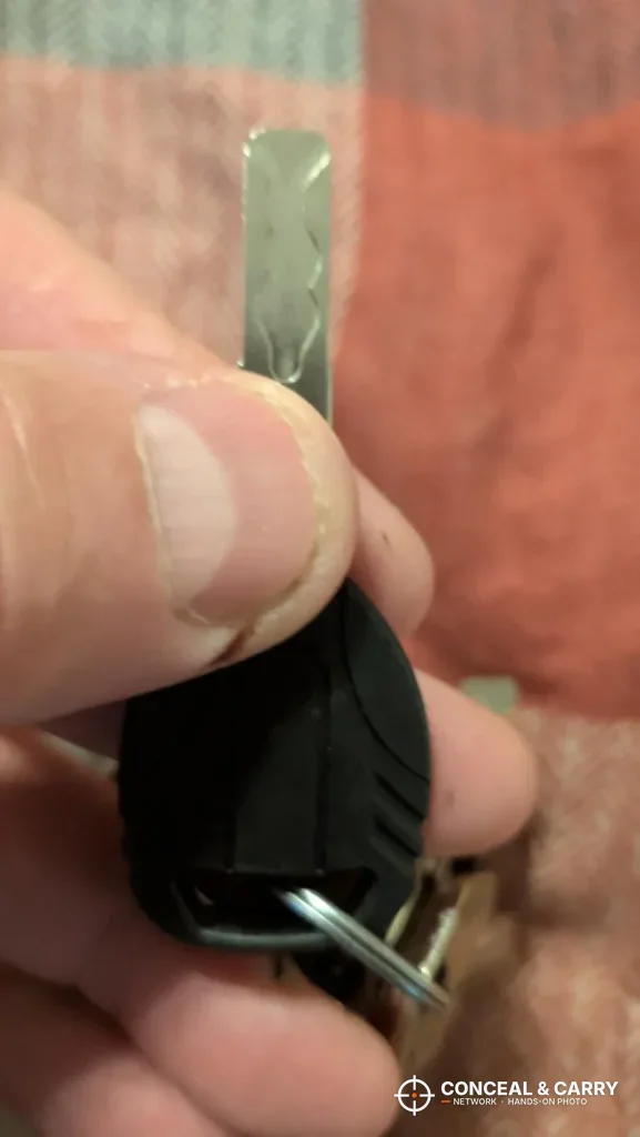 Backup key for the Grimtron portable car gun safe held in hand